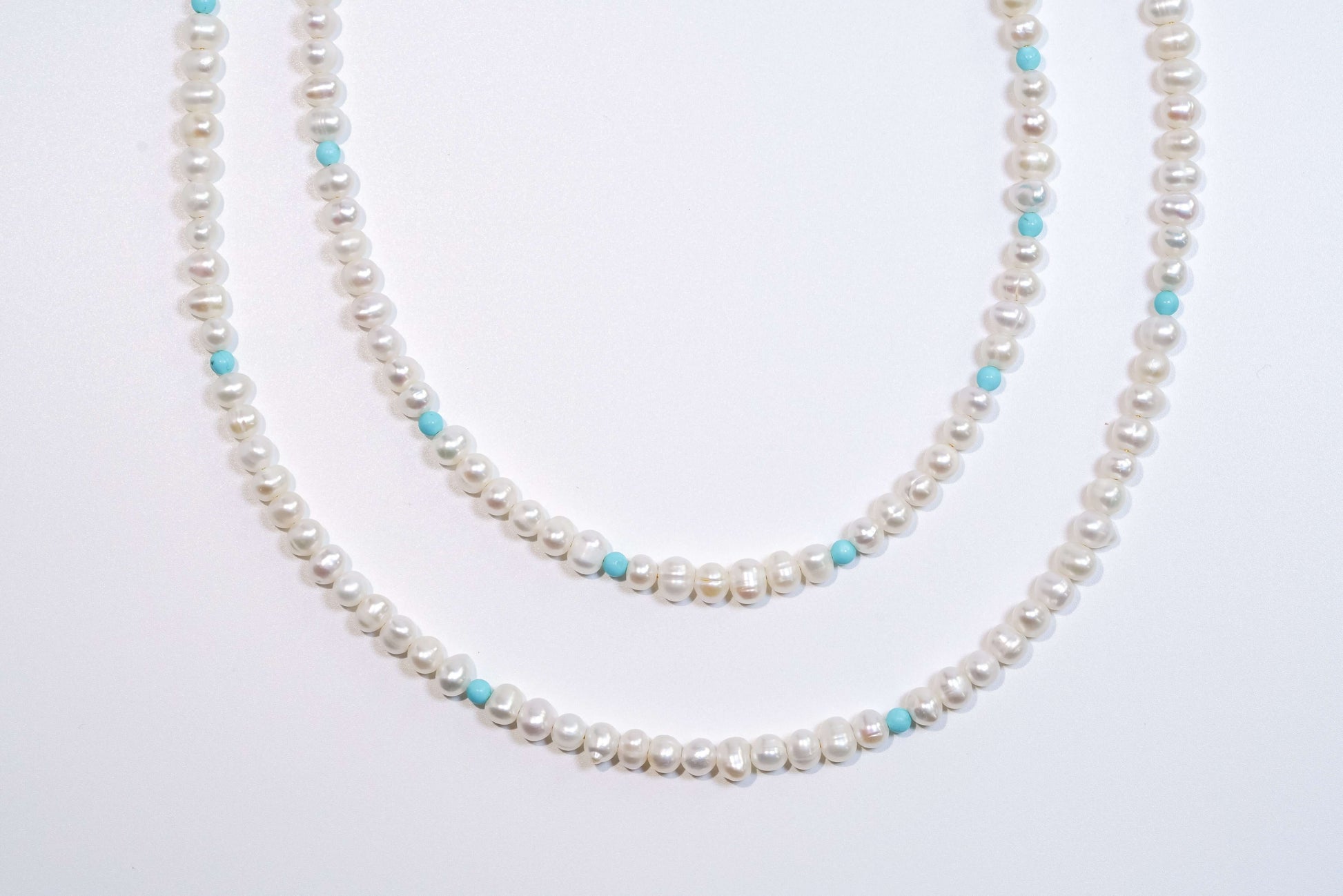 Elegant pearl-turquoise cross-body phone strap, featuring freshwater pearls, turquoise, and silver hardware, 120cm long.