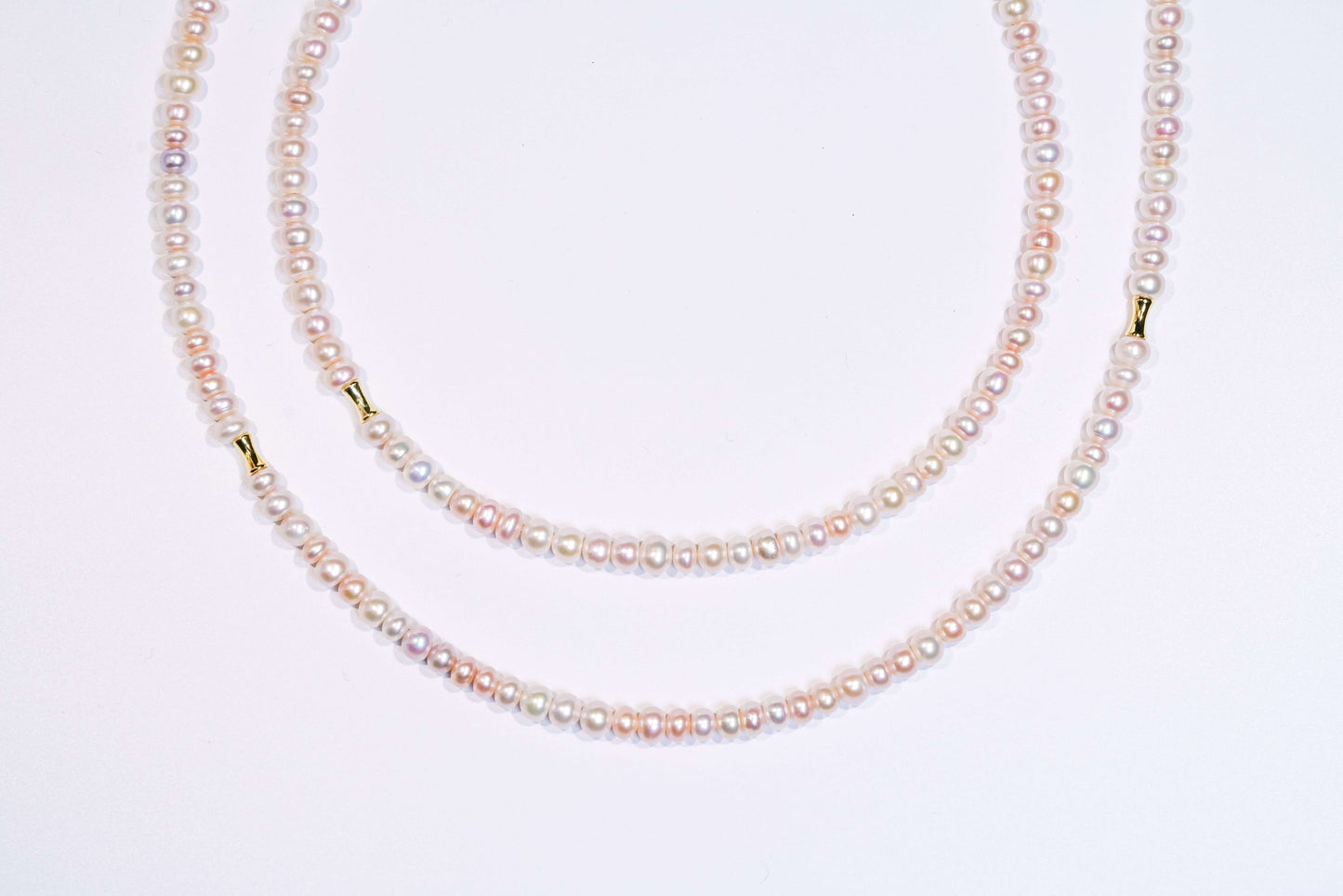 Candy pearl cross-body phone strap necklace with natural pearls and silver accents, stylish and vibrant.