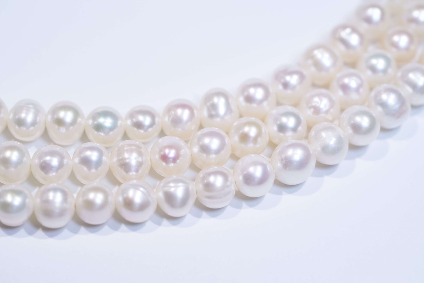 Close-up of natural white pearls showcasing luster, suitable for a classic pearl cross-body phone strap and necklace.