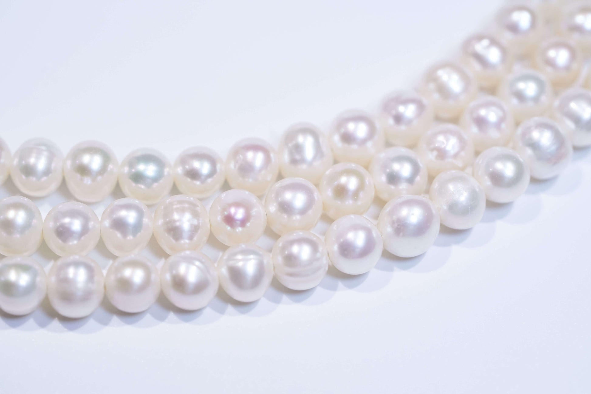 Close-up of natural white pearls showcasing luster, suitable for a classic pearl cross-body phone strap and necklace.