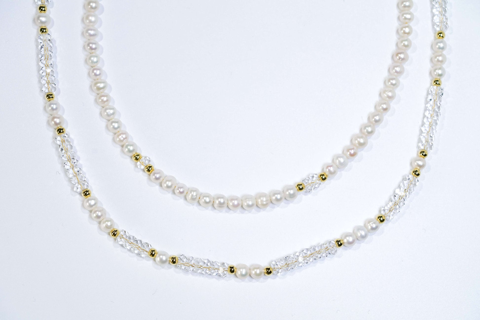 Elegant Pearl-White Crystal Cross-body Phone Strap/ Necklace with gold accents, showcasing smooth lines and handcrafted design.