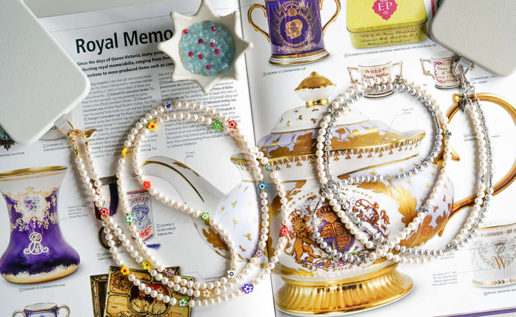 Jewel cross-body phone straps with all-natural pearls on a tea-themed magazine, showcasing a two-way necklace design.