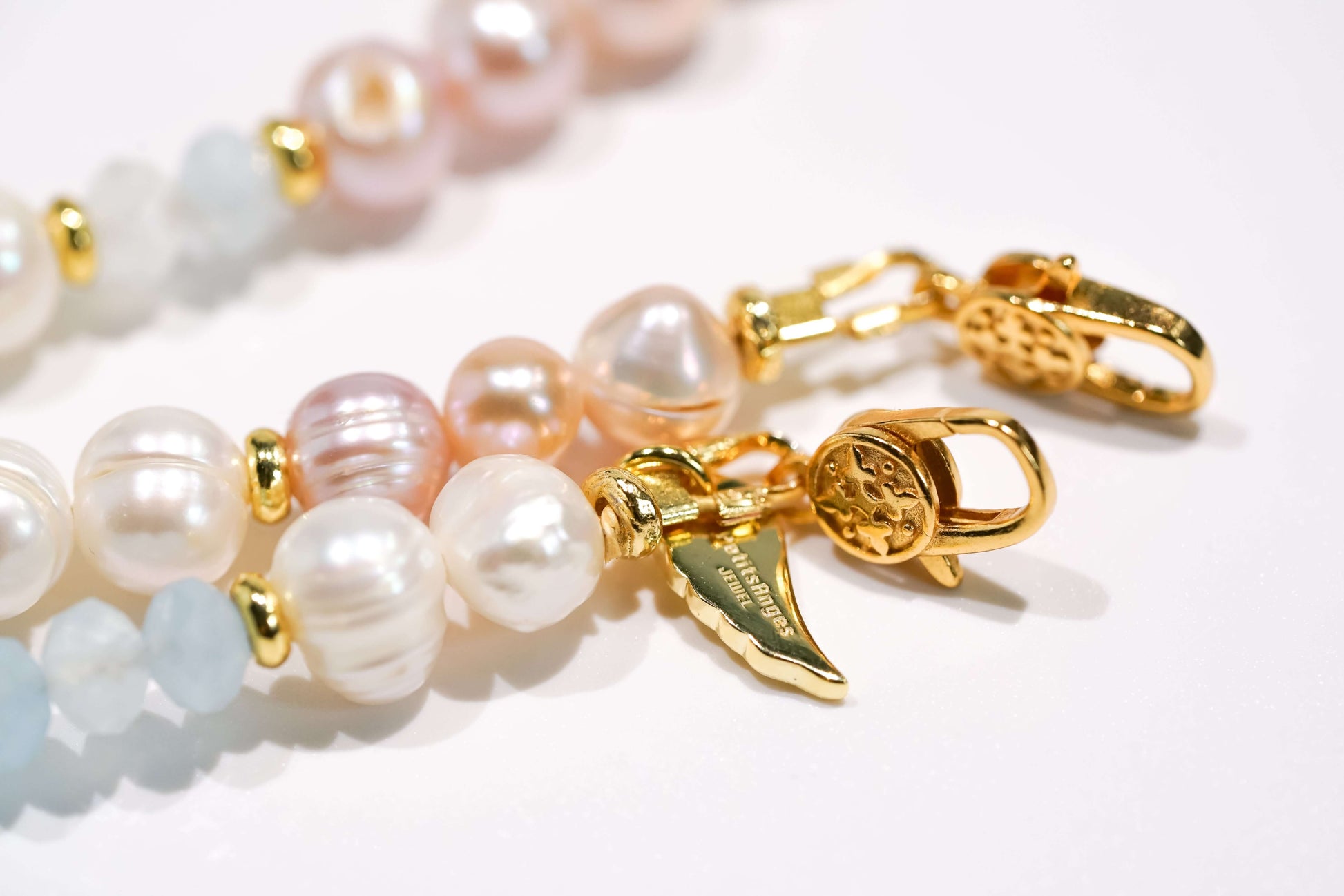 Pearl and aquamarine cross-body phone strap with gold clasps, featuring natural baroque and freshwater pearls.