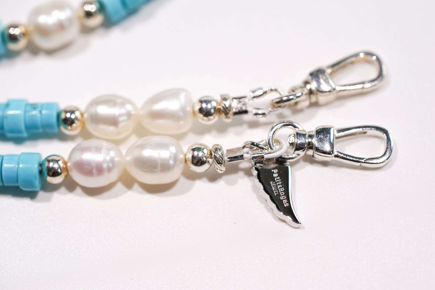 Pearl turquoise cross-body phone strap with S925 silver hardware and freshwater pearls close-up.