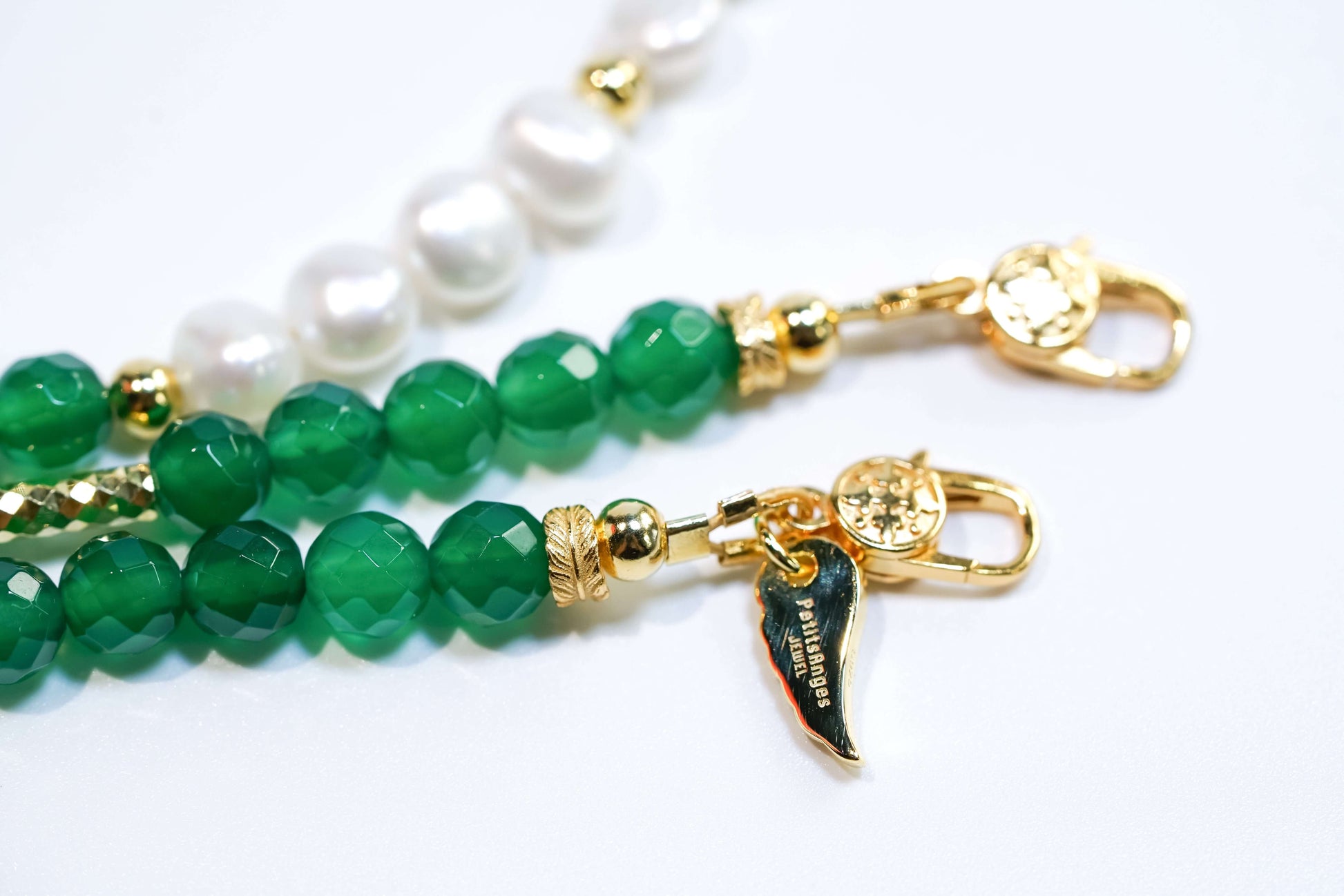 Natural baroque pearls and green agate cross-body phone strap with gold hardware detailing.