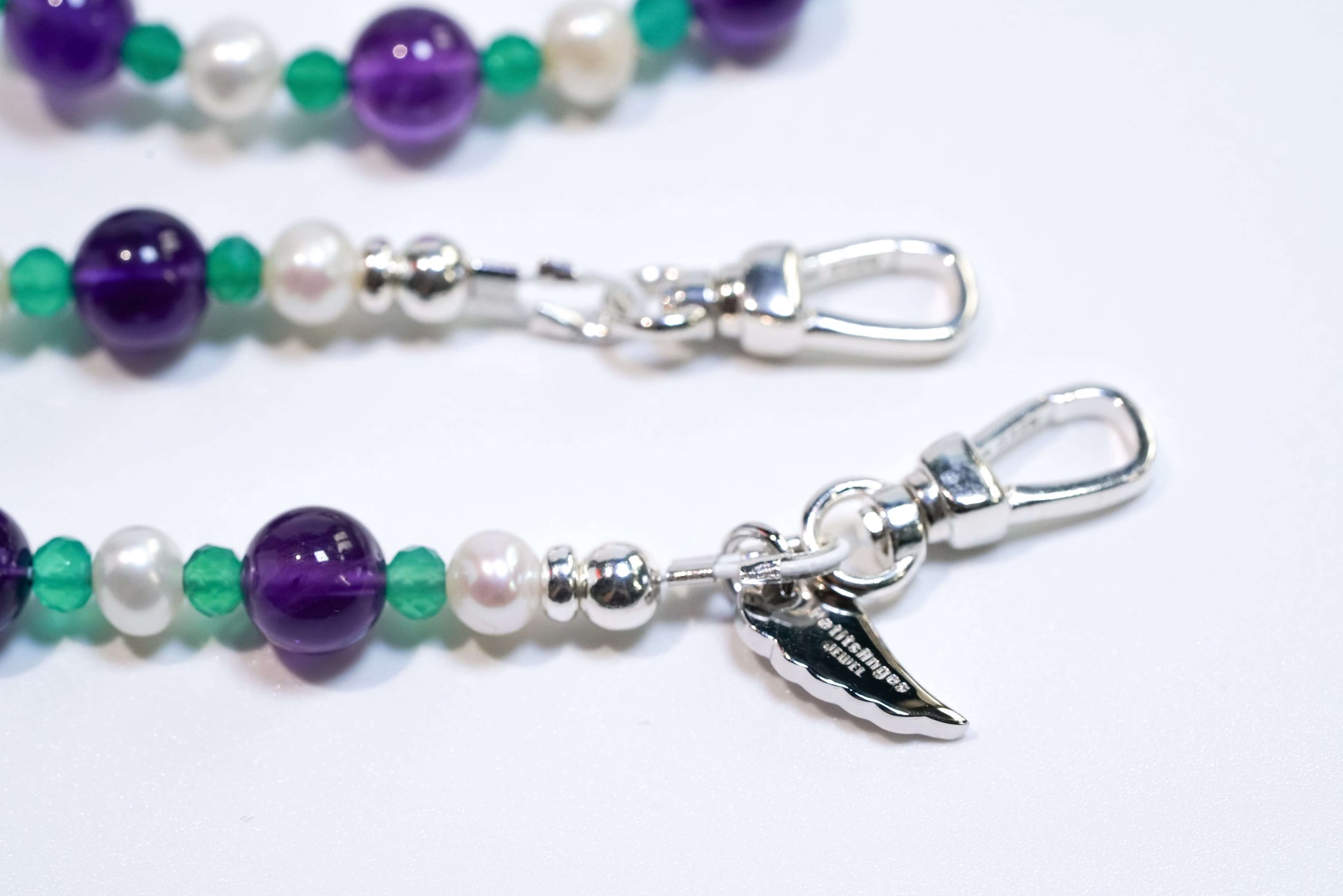 Elegant cross-body phone strap with natural pearls, amethyst, green agate, and S925 silver hardware, promoting balance and style.