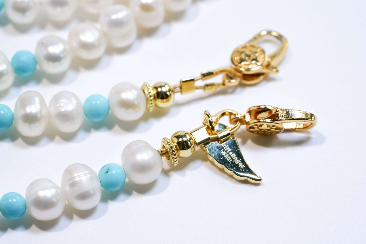 Pearl and turquoise cross-body phone strap with S925 silver plated 18K gold hardware, featuring freshwater pearls and turquoise beads.