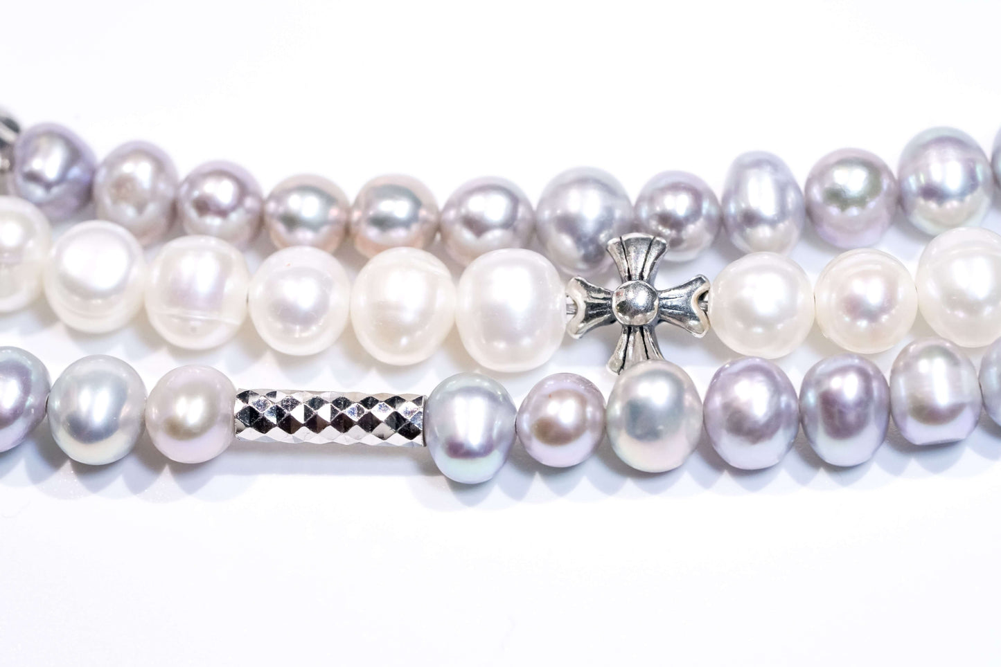 Silver and white freshwater pearl cross-body phone strap with S925 silver charm, showcasing stylish design and versatility.