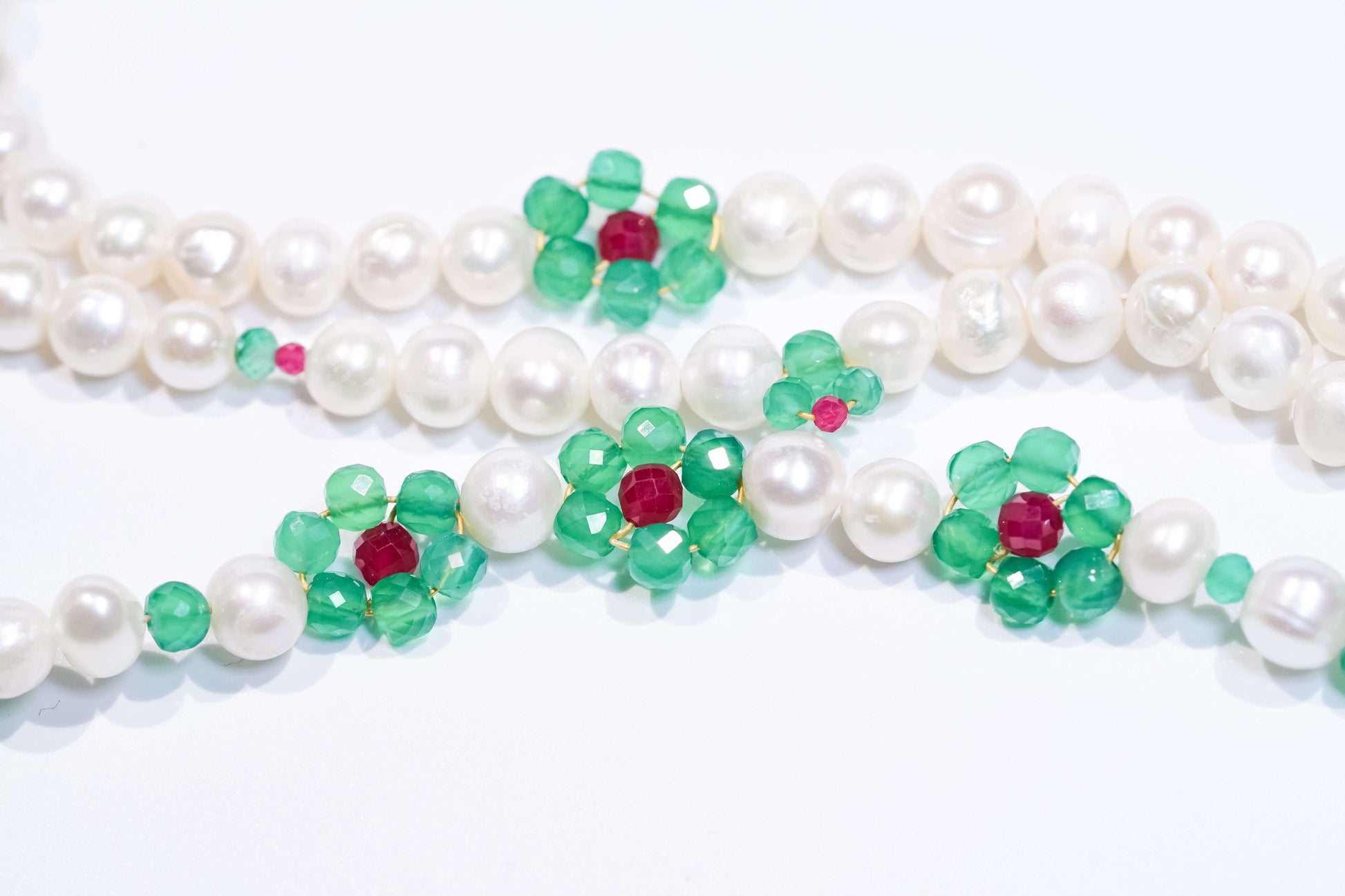 Pearl-green agate and ruby cross-body phone strap/necklace with floral design and natural pearls.