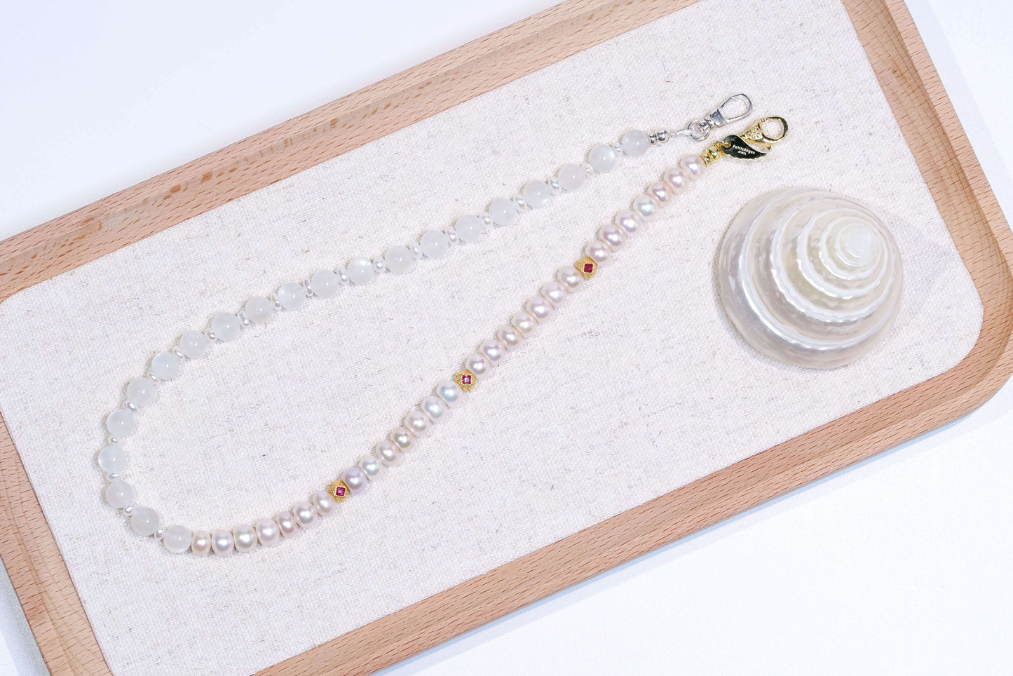 Pearl-Moonstone Silver Phone Charm and Bracelet featuring natural pearls and moonstone on a wooden background.